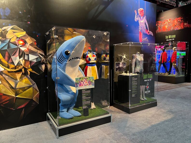 An exhibit showing the "left shark" costume alongside Katy Perry's costume from her Super Bowl Halftime Show in 2015