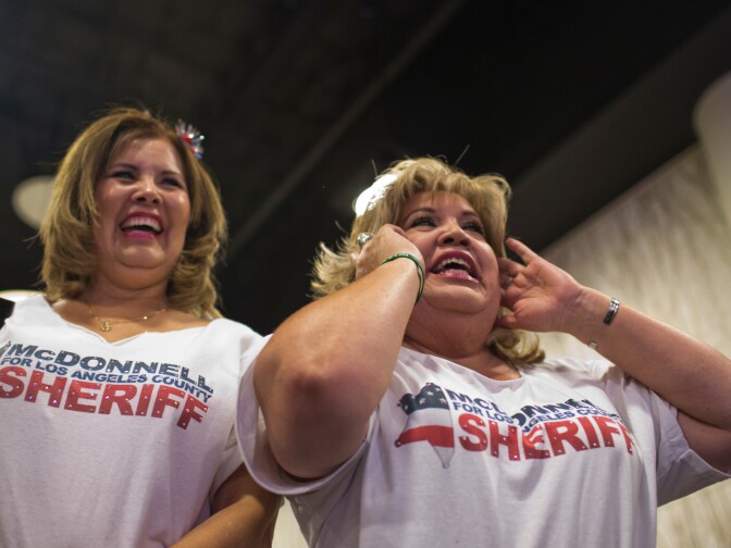 Monica Harman, left, of Speak Out Against Bullying and Michele Arce of the East Los Angeles Chamber wear shirts supporting Los Angeles County Sheriff candidate Jim McDonnell during his election gathering at the JW Marriott in downtown Los Angeles on Tuesday night, June 3. Harman and Arce have known McDonnell for almost two decades.