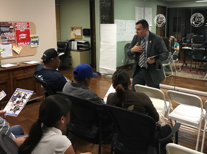 Hugo Salazar from the Orange County Labor Federation gives a know your rights talk to immigrants waiting to sign power of attorney documents in case they are detained or deported. 