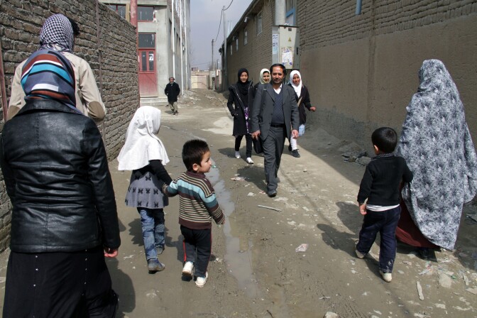 Aziz Royesh (center) in the streets near the Marefat School in Kabul.