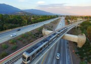 A Gold Line train heads over the eastbound 210 toward Arcadia Station.