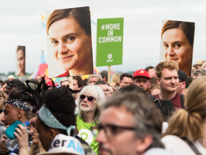 Festival goers hold placards to remember Jo Cox at an event on the Park stage during the Glastonbury Festival at Worthy Farm, Pilton on June 23, 2016 in Glastonbury, England. The Labour MP for Batley and Spen was shot and stabbed in the street on June 16 and later died. A fund set up in her name has raised over £1.23 M GBP to date.  