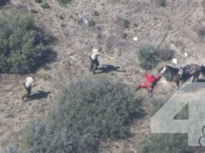 Still image of officers in San Bernardino County apprehending a suspect. The image came from an NBC NewsChopper4 video that shows deputies beating the suspect after leading officers on a wild chase. 