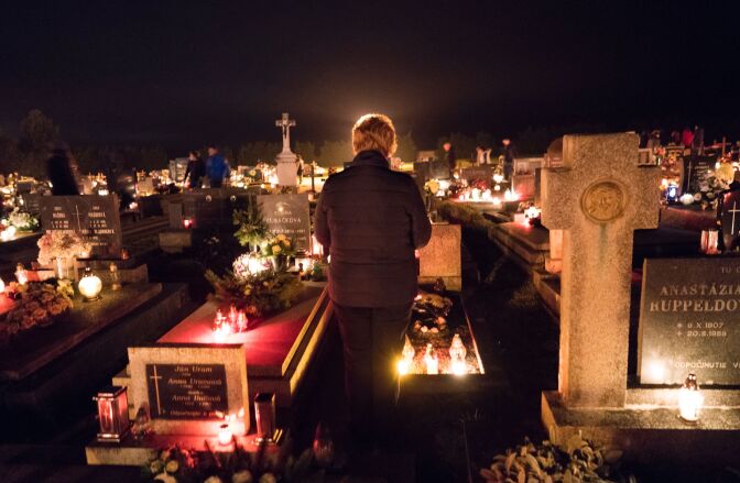 People visit a cemetery to pay respects to their ancestors on All Saints Day in the northern Slovakian village of Bobrovec on November 1, 2016.