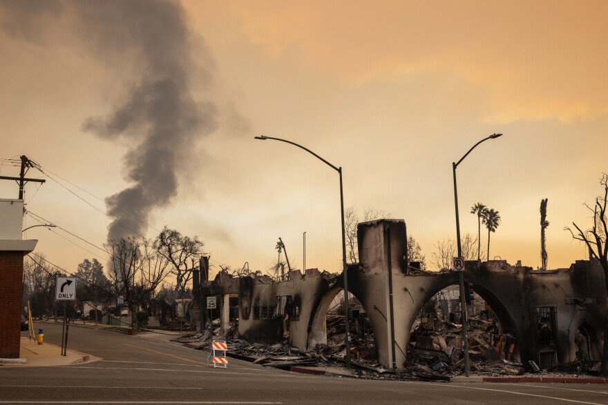 Smoldering ruins along a street.