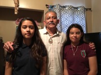 Romulo Avelica Gonzalez at home Thursday with daughters Fatima, 14, left, and Yuleni, 12. Avelica had just dropped off Yuleni at school in February when he was arrested by immigration agents. Fatima, who was in the car, videotaped the arrest.