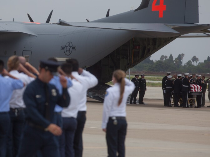 The body of firefighter Kevin Woyjeck, 21, is unloaded from a plane that carried the fallen from Arizona.