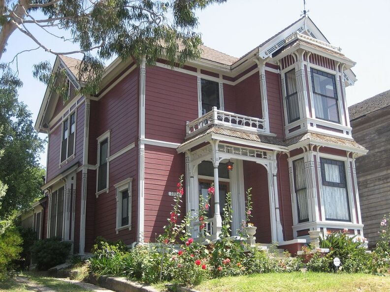 A burgundy two-story home with white features is featured on the TV series Charmed.