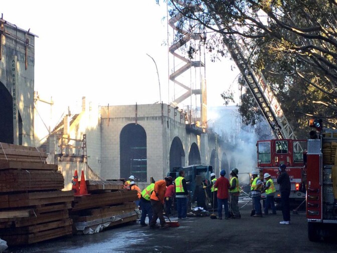 The view from North Fremont Street in downtown L.A. shows the fire still smoldering in some areas.