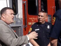 Councilman Jim Ayres speaks with firefighters