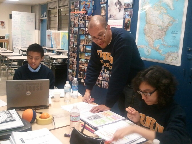 Franklin High School AcaDeca coach Sam Cullens works with two of his decathletes. 