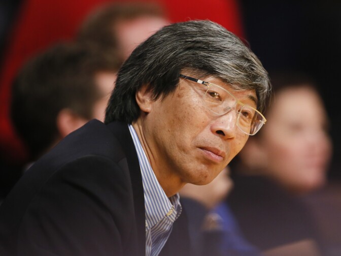 Dr. Patrick Soon-Shiong sits courtside as the Los Angeles Lakers play against the Utah Jazz during the second half of an NBA basketball game in Los Angeles, Tuesday, Feb. 11, 2014. The Jazz won 96-79. (AP Photo/Danny Moloshok)