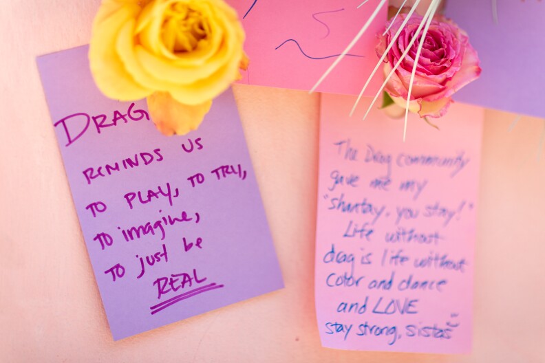 Attendees leave notes about the importance of drag to them, or messages to the community, on the art installation by Classroom of Compassion at Drag March L.A. on Sunday.