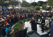 People gather in Whittier for a vigil for police officer Keith Boyer, who was shot and killed Monday morning after he and another officer tried to pat down a motorist involved in a traffic accident. The man was driving a stolen car officials say was connected to a murder hours earlier.