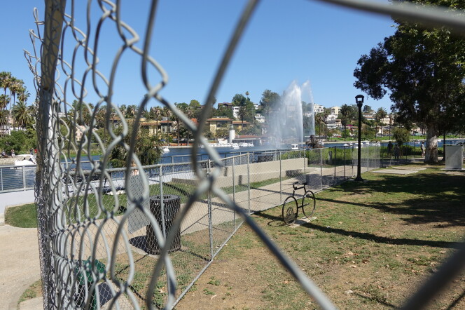 Image of a chain link fence that surrounds the perimeter of Echo Park Lake.