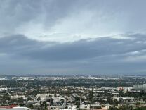 Dark clouds gather over a city