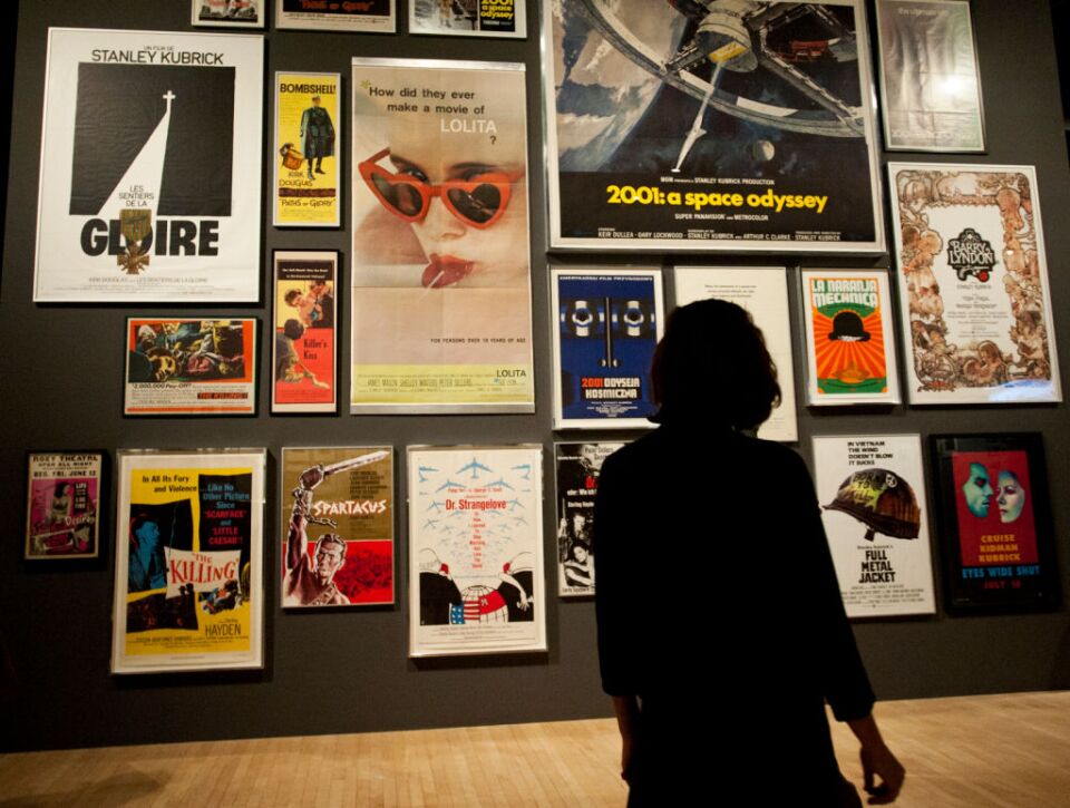 Viewers look at posters for Kubrick's films in the entrance to the exhibit. Kubrick is known for films such as "A Clockwork Orange," "2001: A Space Odyssey," and "Eyes Wide Shut."