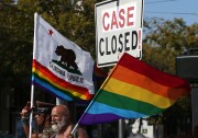 Same-sex marriage supporters hold pride flags next to an altered street sign that reads "CASE CLOSED!' while celebrating the U.S Supreme Court ruling regarding same-sex marriage on June 26, 2015, in San Francisco. The high court ruled that same-sex couples have the right to marry in all 50 states.