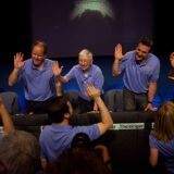 Members of the project leadership team pass out high fives to engineers from mission control before a press conference at the Jet Propulsion Laboratory Sunday night.