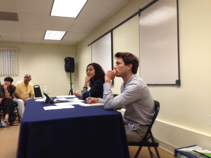 City planners Patricia Diefenderfer and Alex Heath take testimony from nearly 30 people at the zoning hearing. 