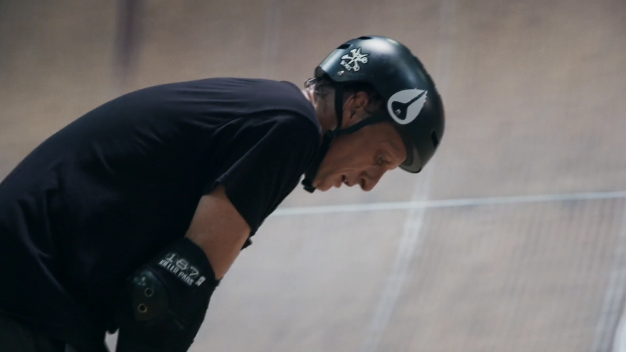 Tony Hawk on a skate ramp looking exhausted