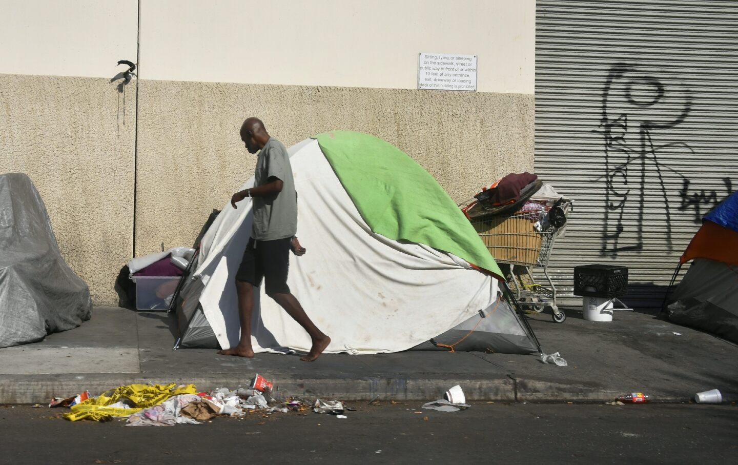Tents house the homeless on a street, November 10, 2017 in Los Angeles, California, home to one of the nation's largest homeless populations, and where health officials are trying to ramp up efforts to stop the spread of Hepatitis A, as numbers are beginning to surge among gay and bisexual men, but not the homeless. The highly contagious liver disease can spread easily through homeless populations because of unsaintary conditions.
  / AFP PHOTO / FREDERIC J. BROWN        (Photo credit should read FREDERIC J. BROWN/AFP/Getty Images)