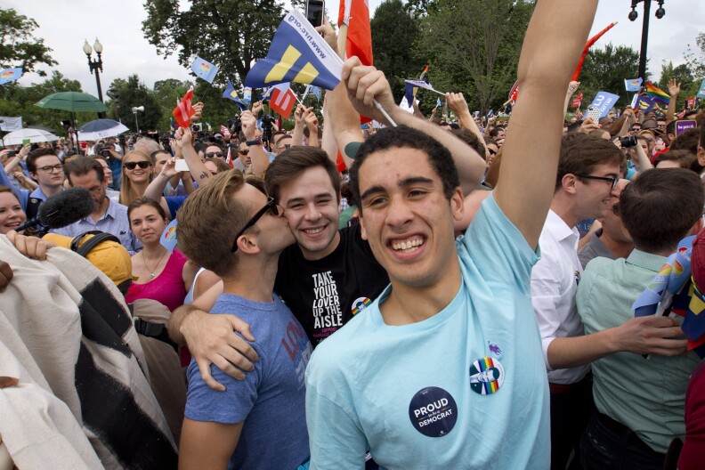 Supporters of same-sex marriage celebrate outside of the Supreme Court in Washington, Friday June 26, 2015, after the court declared that same-sex couples have a right to marry anywhere in the US. (AP Photo/Jacquelyn Martin)