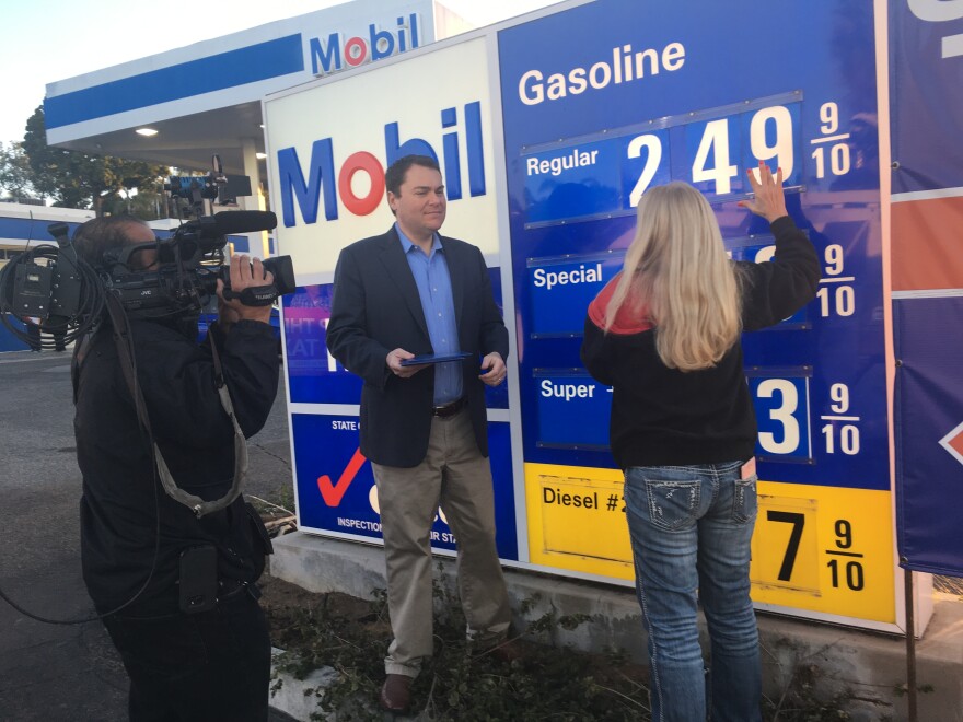Carl DeMaio assists the owner of a Mobil gas station near Interstate 5 in Encinitas as she changes the price sign. DeMaio, of Reform California, used the price-lowering events to draw in potential supporters of a petition to repeal the state's new gas tax.