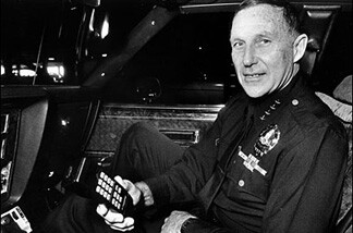 Former L.A. Police Chief Darryl Gates, using his sleek, modern, tiny cell phone, in 1986. Police would actually be exempt from the new cell phone law, and of course they'll never make personal calls while on-duty in their cars.