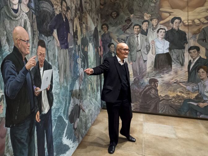 Artist and curator of the "Winds from Fusang: Mexico and China in the Twentieth Century" exhibit, Shengtian Zheng, of Canada, talks about a Mexican artist Diego Rivera inspired mural he helped paint during the media tour of the newly renovated USC Pacific Asia Museum, December 6, 2017.  (Photo/Gus Ruelas)