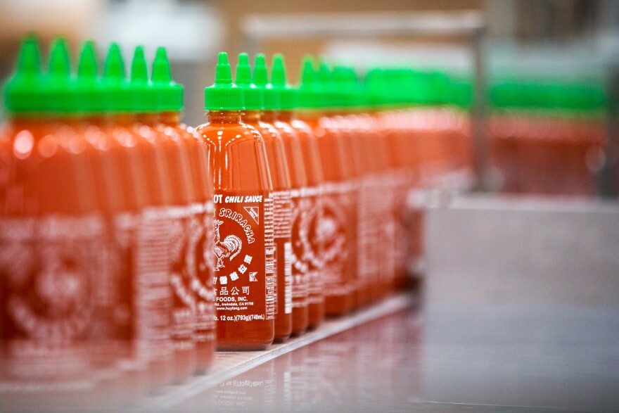 Twenty-eight-ounce bottles of Sriracha hot sauce are transported by conveyor belt to be packed and shipped inside Huy Fong Foods Inc. in Irwindale on Tuesday, Aug. 19.