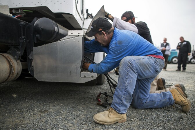 On-site mechanics from Eagle Equipment work to start a Peterbilt 384 liquefied natural gas truck before it is driven onto the auditorium floor at Ritchie Bros. Auctioneers in Perris, Calif. on Friday, Dec. 9, 2016. Richard Newell, a used truck dealer in Fontana, says the trucks don't start, run out of fuel and have sensor and gas tank problems.
