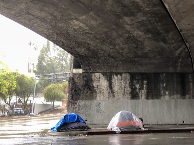 Two tents in Hollywood erected beneath the 101 Freeway during a January rainstorm. (Matt Tinoco/KPCC)