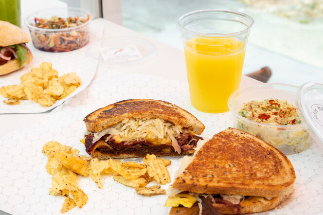 Maciel’s Rueben Sandwich made with pastrami and sauerkraut with a side of potato salad and chips, and a pineapple agua fresca.  
