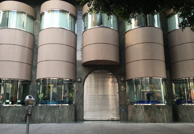 A storefront with an empty sidewalk.
