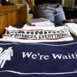 A member of the U.S. teen celibacy group Silver Ring Thing waits near a merchandise counter at Holy Trinity Church.