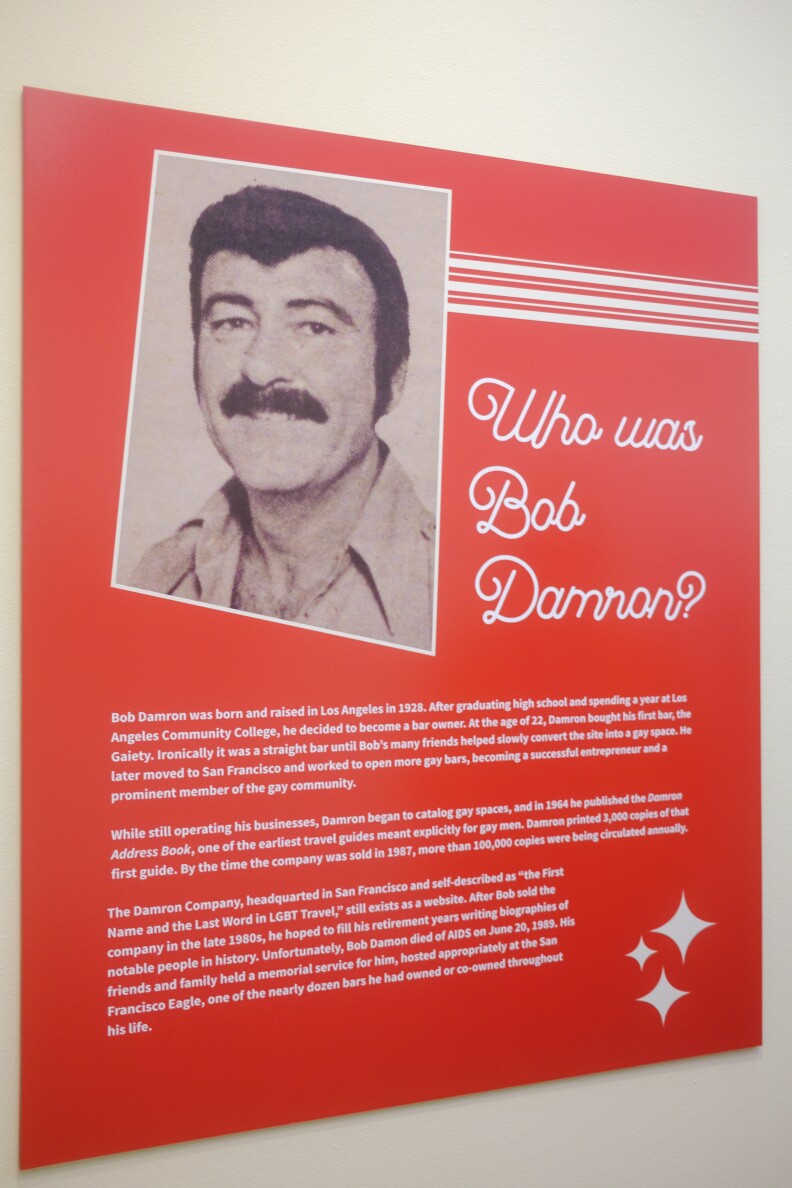 A red plaque displays black and white photo of Bob Damron