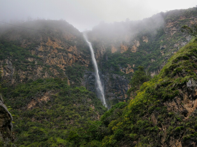 Enjoying a waterfall in Colombia, after being guided to the spot by guerrillas in army fatigues