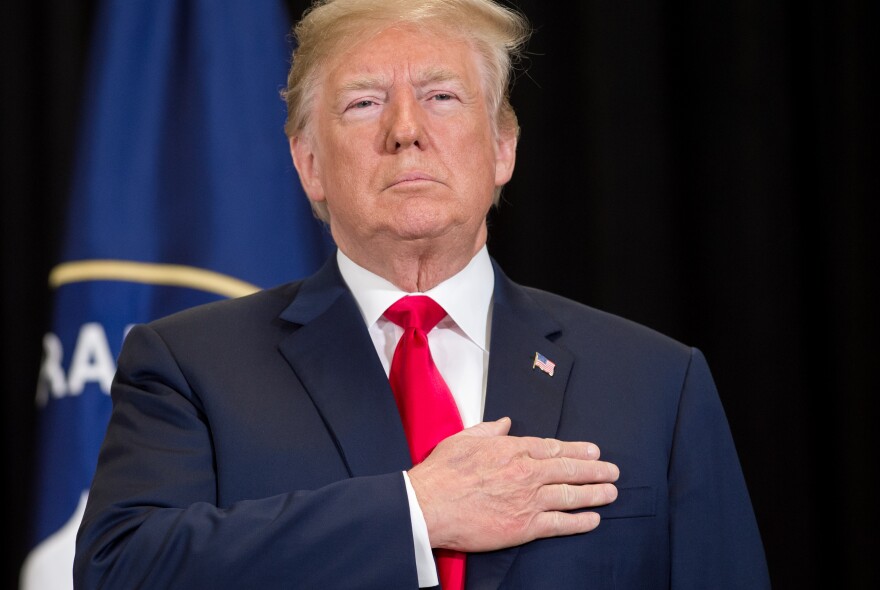 US President Donald Trump stands for the National Anthem during a swearing-in ceremony for Gina Haspel as Director of the Central Intelligence Agency at CIA Headquarters in Langley, Virginia, May 21, 2018. (Photo by SAUL LOEB / AFP)        (Photo credit should read SAUL LOEB/AFP/Getty Images)