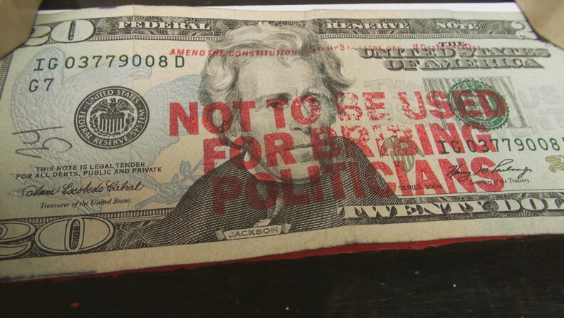 “Not to be used for bribing politicians” stamped on $20 bill. From the HBO documentary "Meet the Donors: Does Money Talk?" 