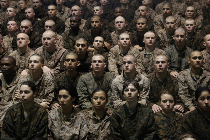 PARRIS ISLAND, SC - FEBRUARY 25:  Female and male Marine recruits listen to instructions as they prepare for a swimming test during boot camp February 25, 2013 at MCRD Parris Island, South Carolina. Male and female recruits are expected to meet the same standards during their swim qualification test. All female enlisted Marines and male Marines who were living east of the Mississippi River when they were recruited attend boot camp at Parris Island. About six percent of enlisted Marines are female.  (Photo by Scott Olson/Getty Images)