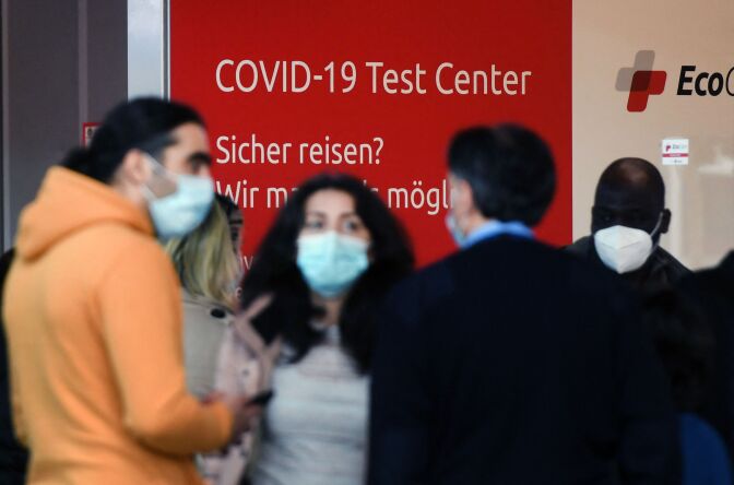 Passengers queue at a Covid-19 test center at the departure level at the Duesseldorf airport, western Germany on March 26, 2021. - As of the night from March 30 to 31, the new Corona test obligation is to apply to all travellers who want to enter Germany by plane. (Photo by Ina FASSBENDER / AFP) (Photo by INA FASSBENDER/AFP via Getty Images)