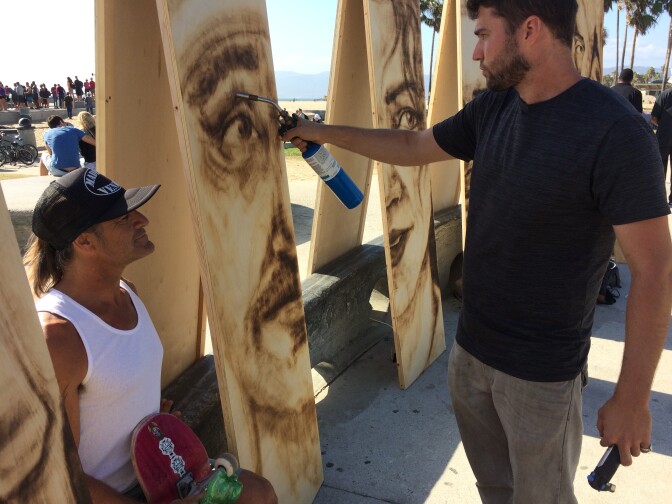 Paul Anthony Ruiz, a long time Venice resident and skater, gets his portrait done by Aronson.