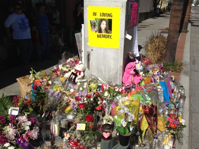 Photos, personal messages, flowers and candles at Fourth Street and Broadway in downtown Santa Ana in remembrance of Kim Pham.