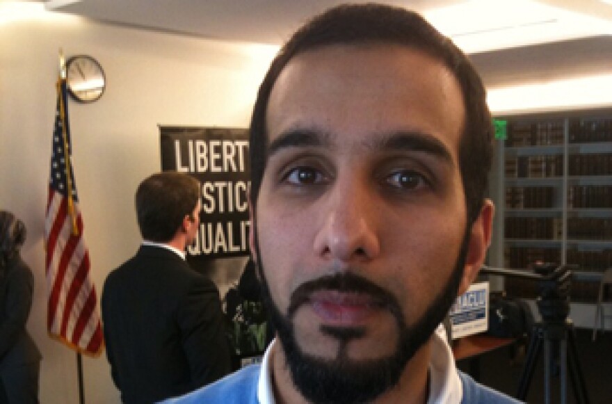 Ali Malik, at a news conference, is one of three plaintiffs named in a lawsuit against the FBI.