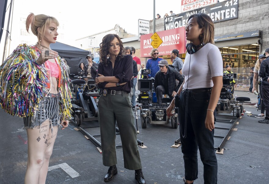 Director Cathy Yan (R) on the set of "Birds of Prey" with actress Margot Robbie (L).