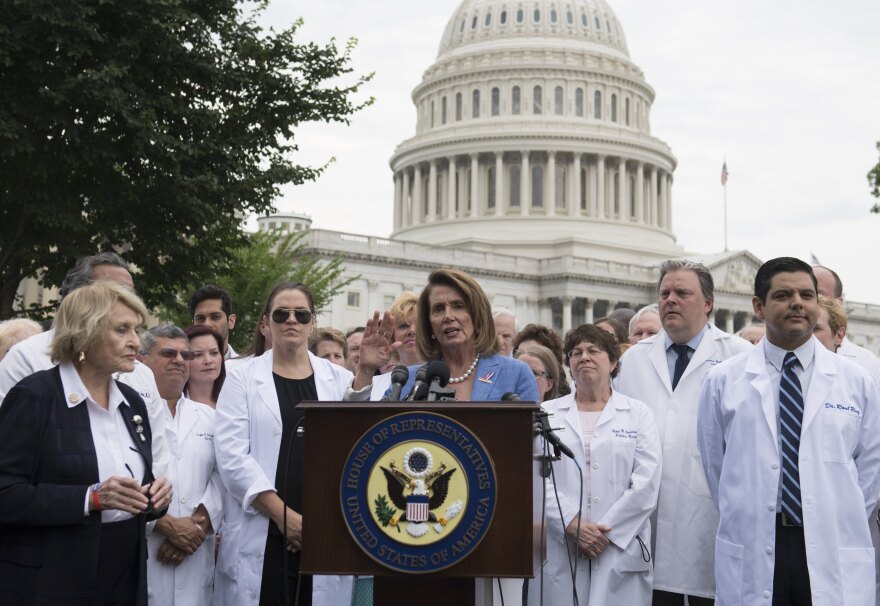 US House Democratic Leader Nancy Pelosi (C), Democrat of California, speaks alongside doctors, nurses and healthcare providers against the Republican healthcare bills during a rally on Capitol Hill in Washington, DC, June 22, 2017. / AFP PHOTO / SAUL LOEB        (Photo credit should read SAUL LOEB/AFP/Getty Images)