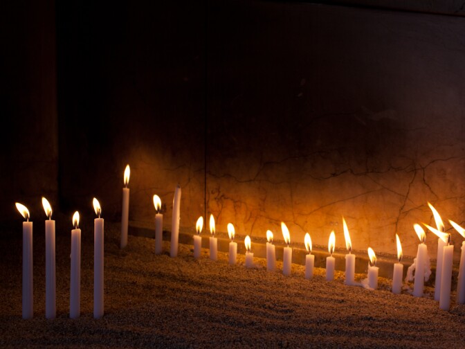 Church goers light candles at St. Mary's Armenian Apostolic Church when they enter the holy space.