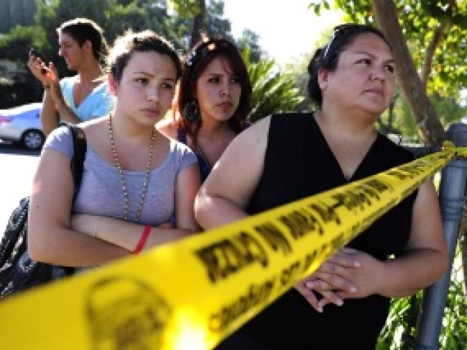 Family members wait for their children outside Gardena High School on Jan. 18, 2011 where two students were shot after a gun in another student's backpack accidentally discharged. From left to right are Eliut Maururi, Elisabeth Guerrero and Maria Avila.