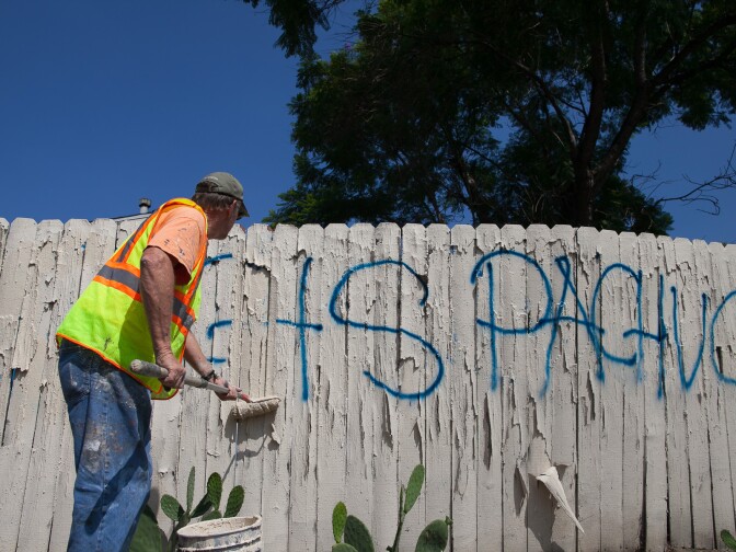 Larry Bender, of Northeast Graffiti Busters, cleans up graffiti on the streets of Highland Park on Tuesday, Aug. 11, 2015. Much of the graffiti he paints over has not been reported yet, and he takes the initiative to cover it up before it "causes more problems," he said. 